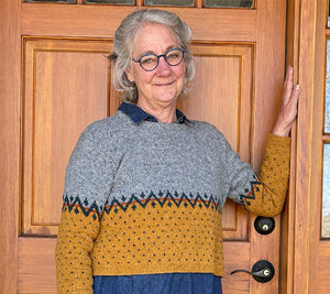 Ann Budd models Cait, a top down set in sleeve pullover designed during class!