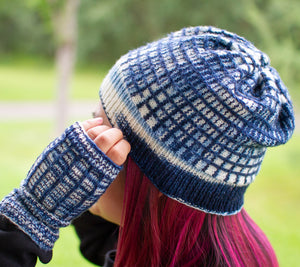 A photo of Gridiron Hat and MItts, demonstrating a clever use of slip stitch wth a long colour repeat in a hand-dyed yarn.