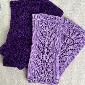 Queen Vicki's wristlets in lavender and purple colours, knit on the knitting machine. Example of lace.