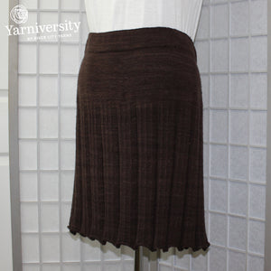 An image of a knitted skirt in dark brown (Rhichard Devrieze Peppino in "Cake").