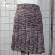 Load image into Gallery viewer, An image of a knitted skirt in a variegated colourway (Manos del Uruguay Alegria).