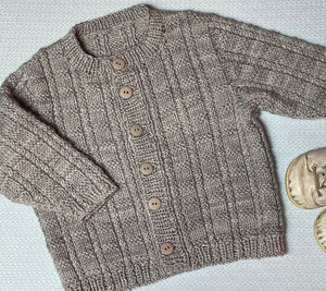 Ann Budd knit this top down, set in sleeve baby cardigan during one of her classes. It's called "Thane".