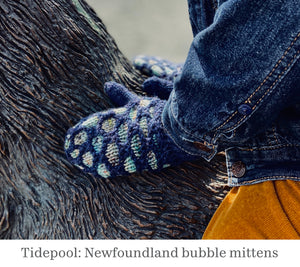 A photo of a child's hand wearing amitten. The mitten pattern is called Tidepool and is from the book, Newfoundland Knits for Little Ones by Katie Noseworthy.
